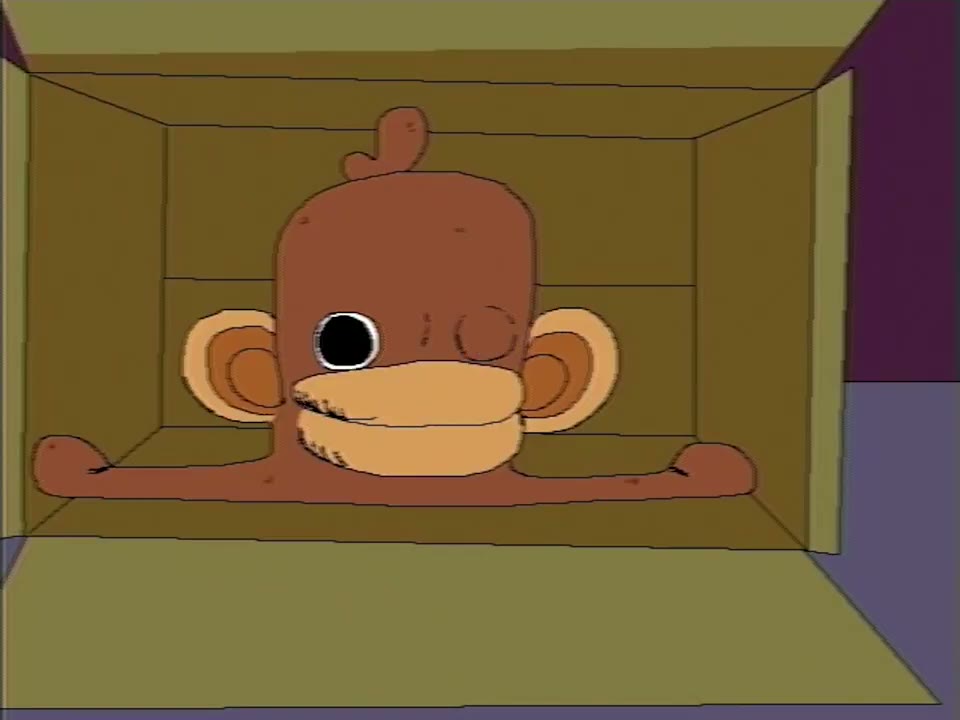 Onkey sitting inside a cardboard box, arms stretched out along the box floor, staring straight ahead.